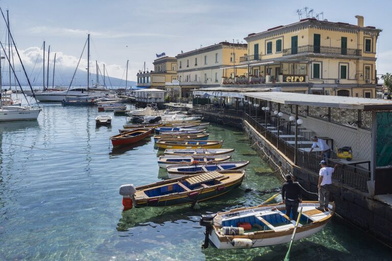 Fishing boats moored in the little harbor of the Borgo Marinari below the seafront of Santa Lucia in Naples
