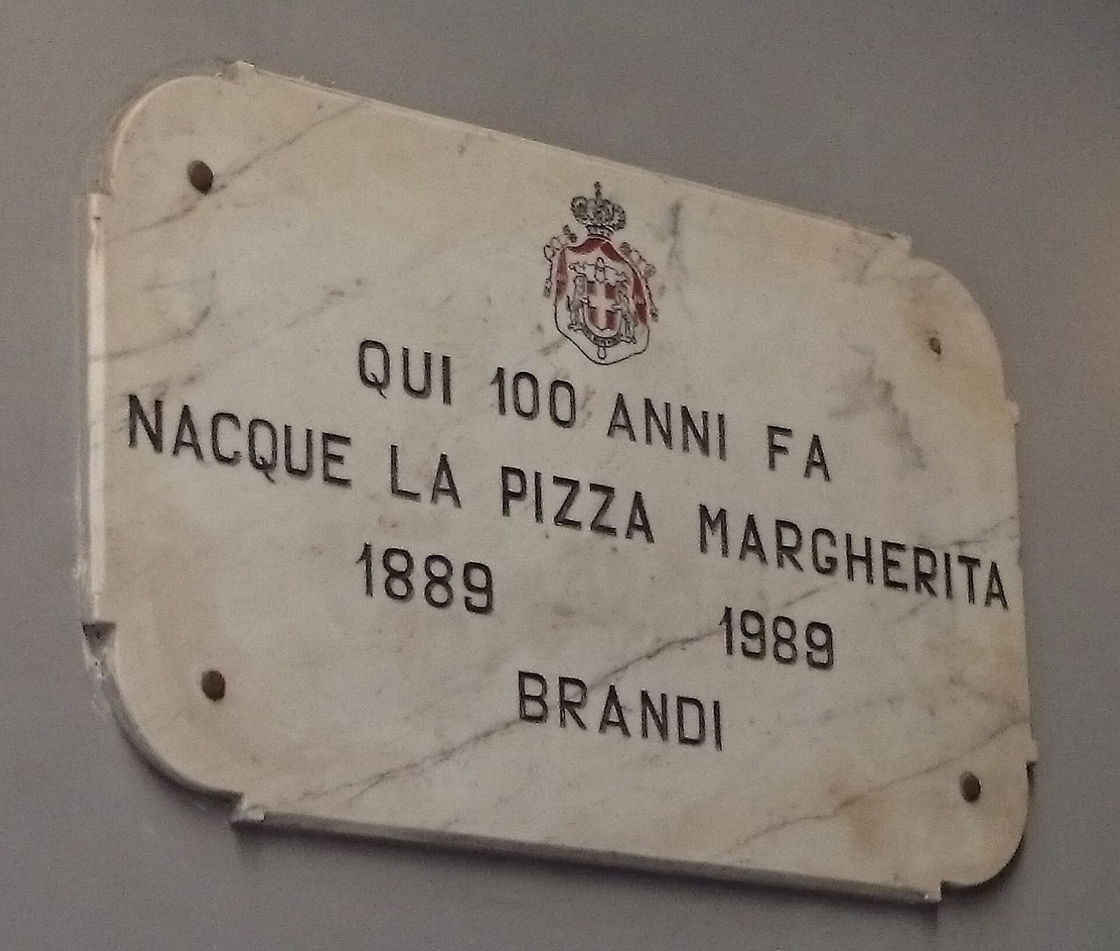 The marble plaque at Pizzeria Brandi in Naples recording the birth of the pizza Margherita in 1889