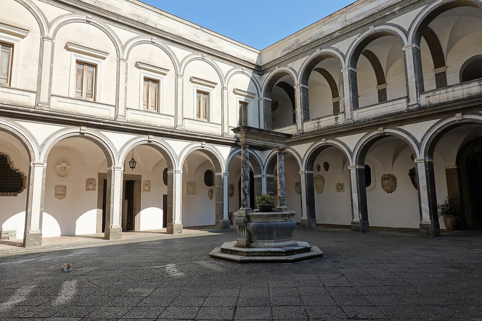 An arcaded cloister with a central well at the Certosa di San Martino in Naples