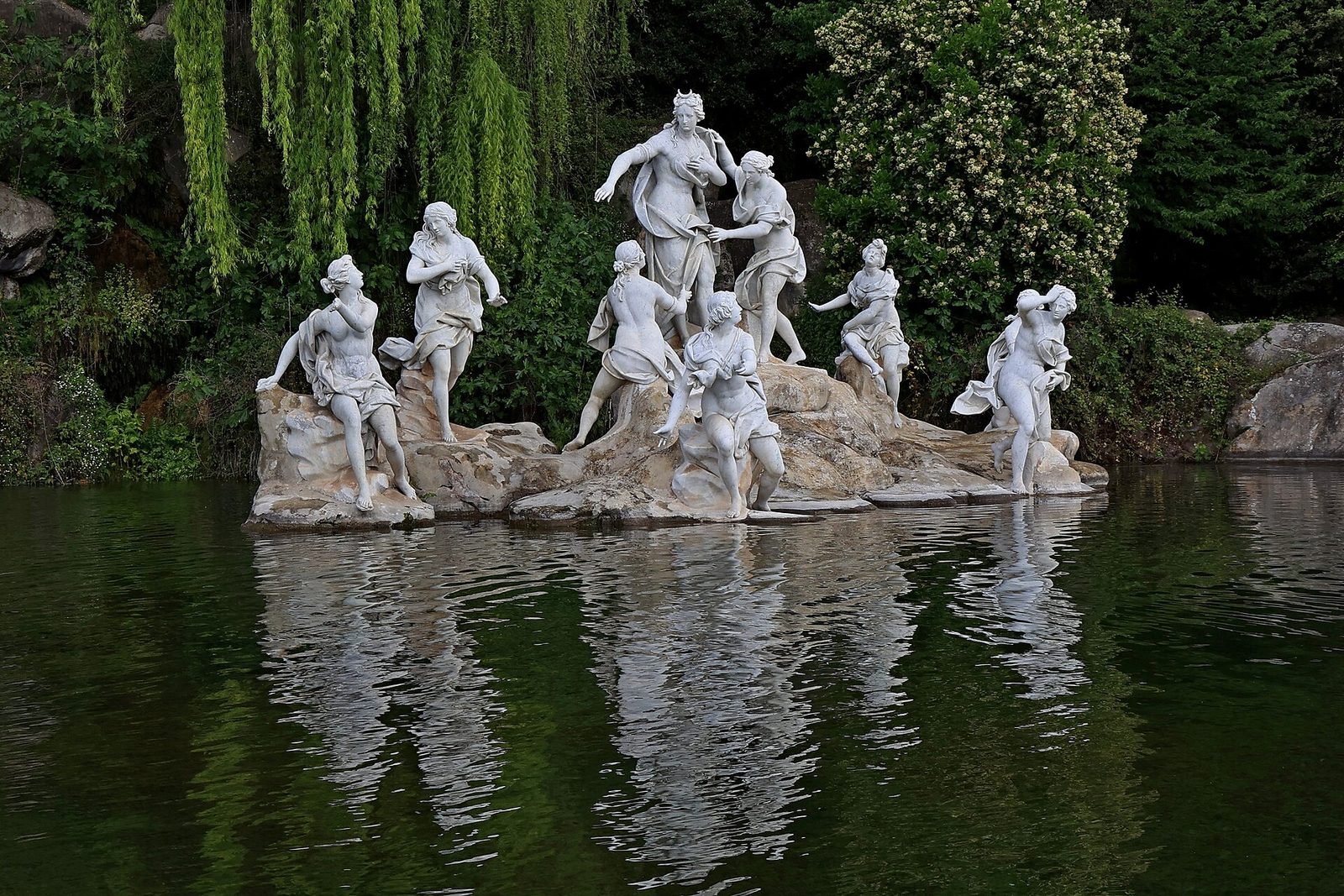 The marble Fountain of Diana and Actaeon reflected in its pool at the top of the Reggia di Caserta park