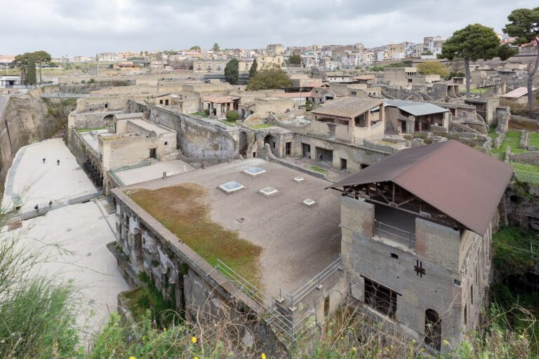 Overview of the excavated Roman town of Herculaneum, with its roofs and streets below modern Ercolano