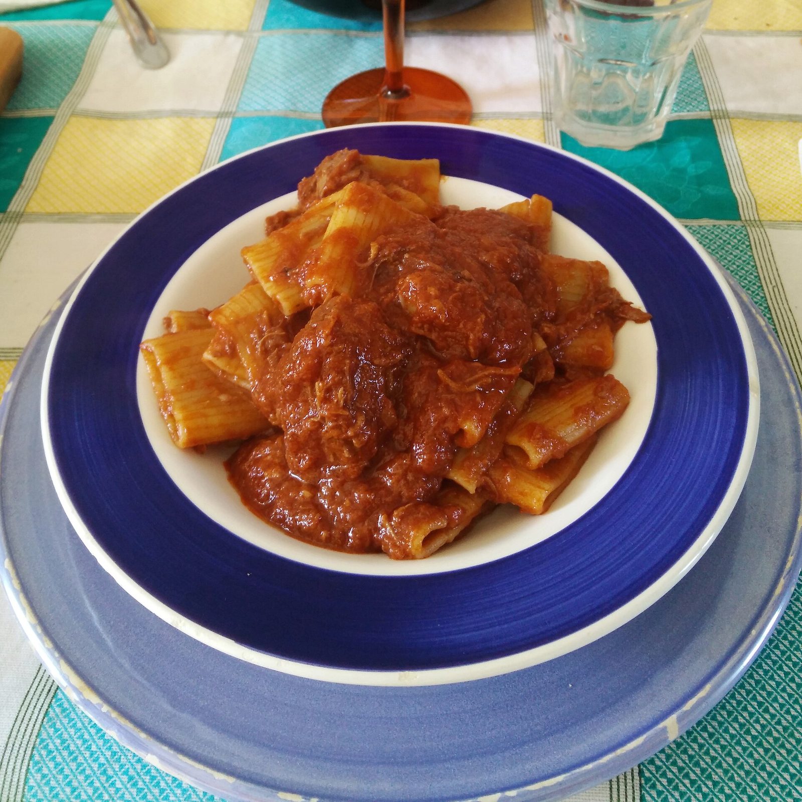 A plate of paccheri rigati pasta with ragù napoletano, the slow-cooked meat and tomato sauce of Naples