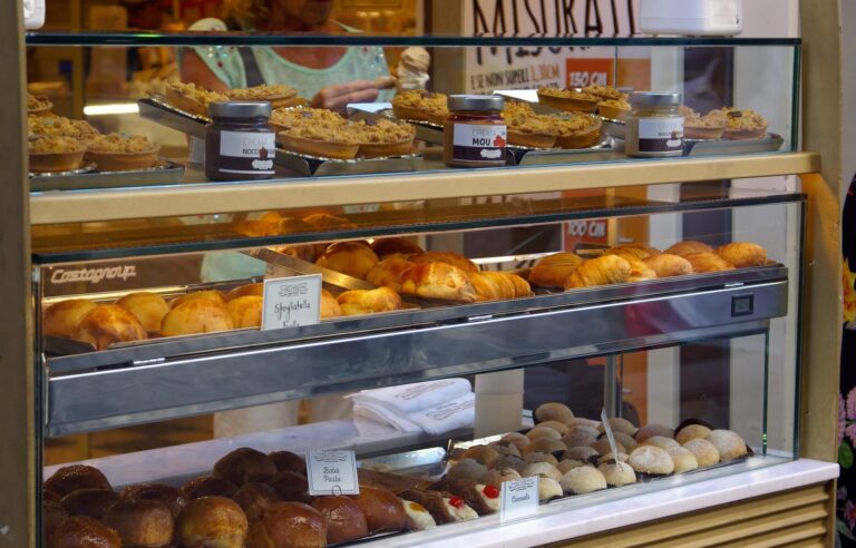 Pastries including sfogliatelle on display in a glass case at a Naples bakery