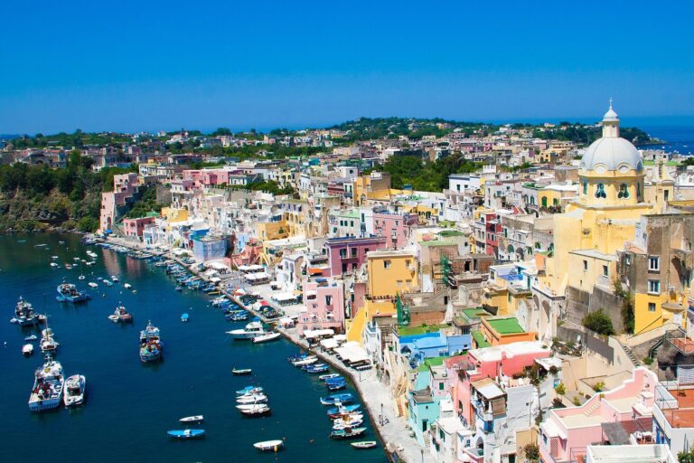The colorful houses and fishing boats of Marina Corricella on Procida, an easy day trip from Naples, Italy