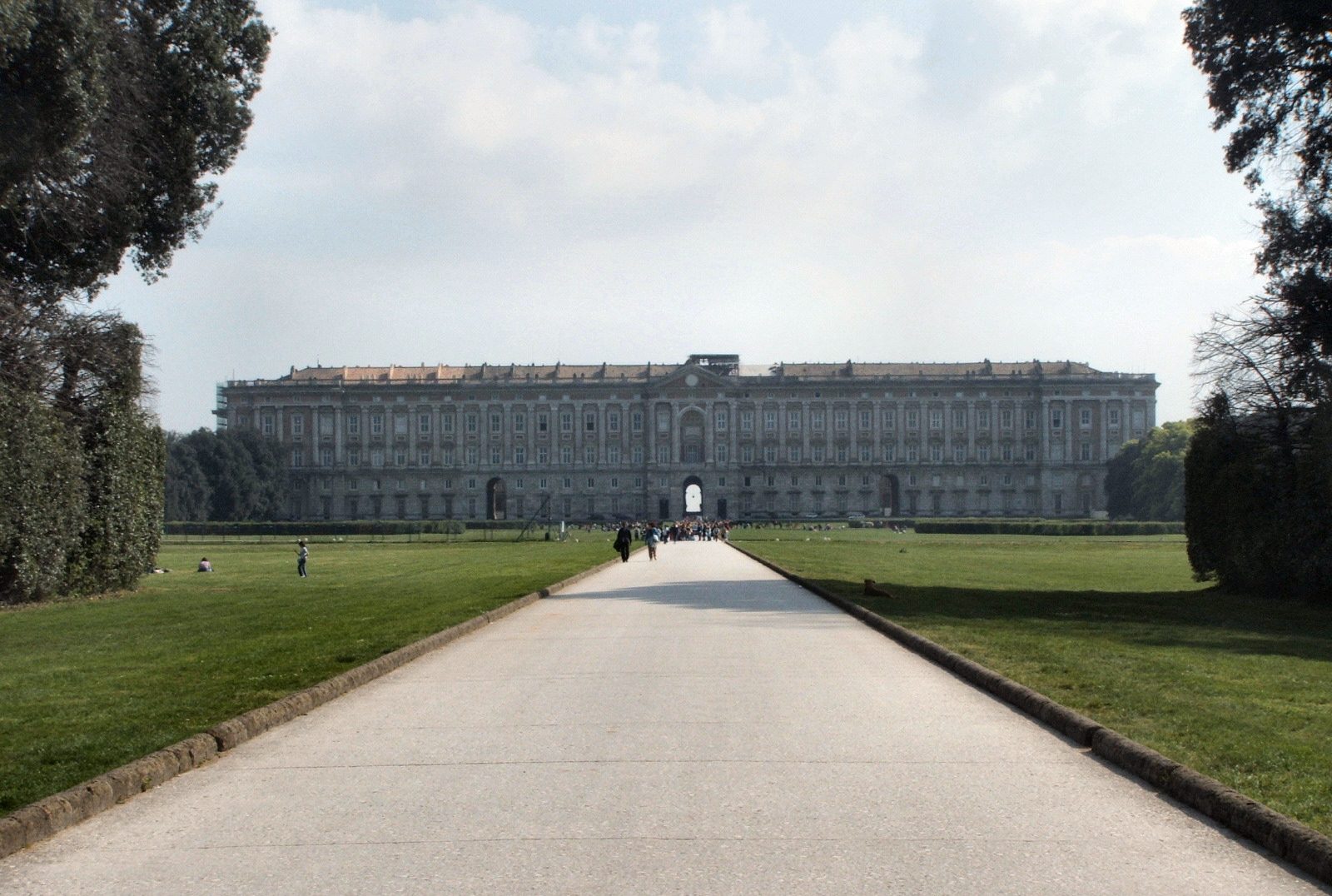 The facade of the Reggia di Caserta royal palace seen from the long avenue of its park