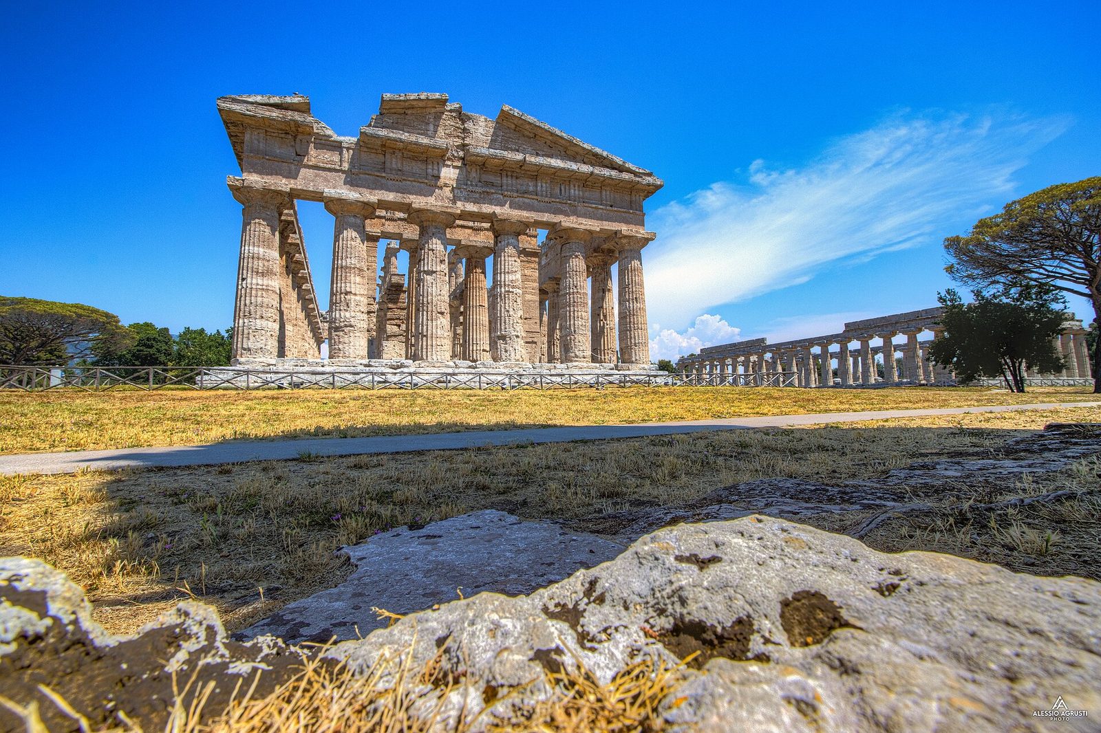 The Doric columns of the Temple of Neptune at Paestum under a deep blue sky
