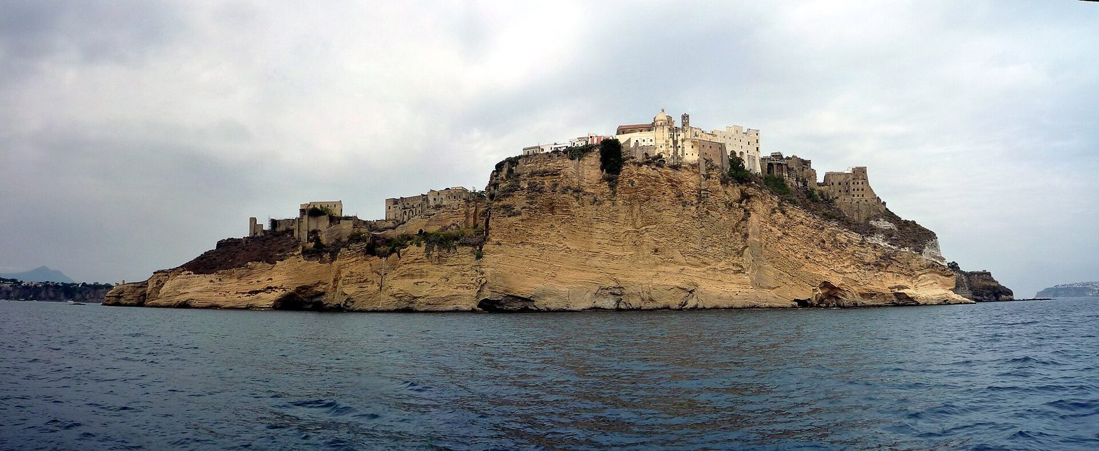 The headland of Terra Murata on Procida seen from the sea, with the walled village and former prison on top