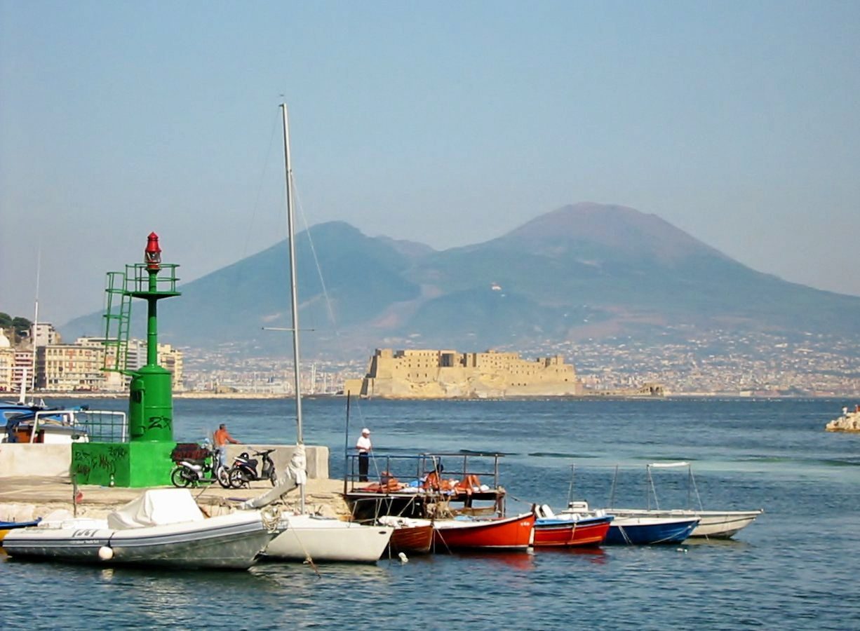 Mount Vesuvius rising above the Bay of Naples, seen from the harbor near Castel dell'Ovo