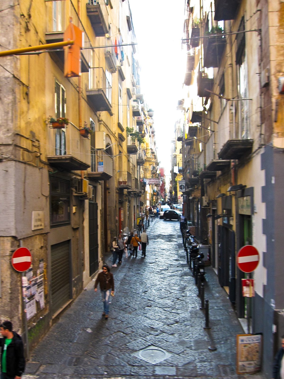 Via dei Tribunali in the centro storico, a narrow street of tall ochre buildings and the first of the things to do in Naples Italy