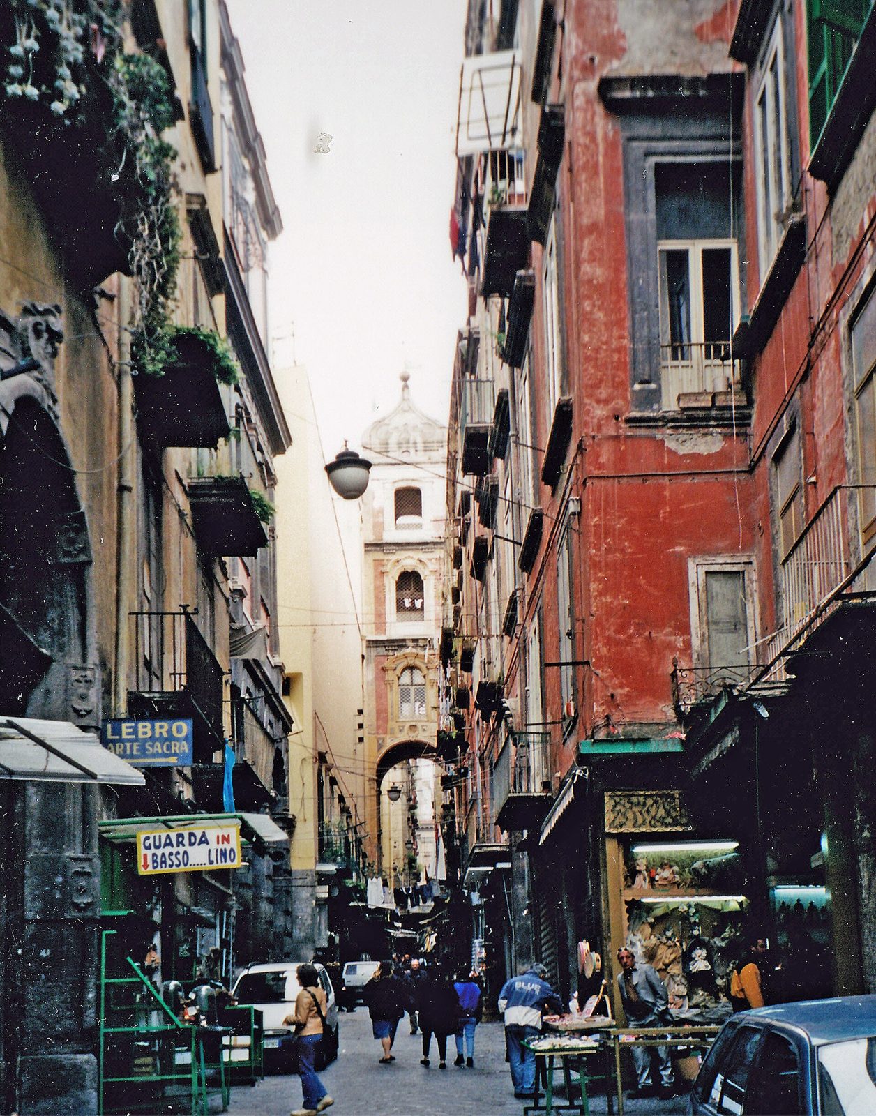 Via San Gregorio Armeno in Naples, with nativity shops and the church bell tower arch above the lane