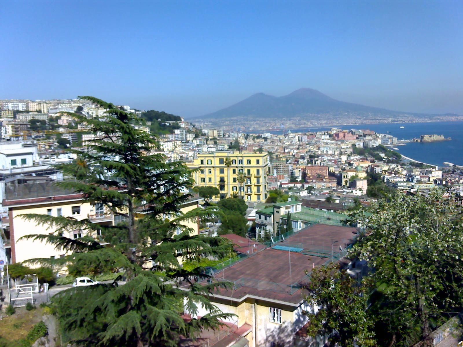 View over the rooftops of Naples to the bay and Mount Vesuvius from the hillside along Corso Vittorio Emanuele