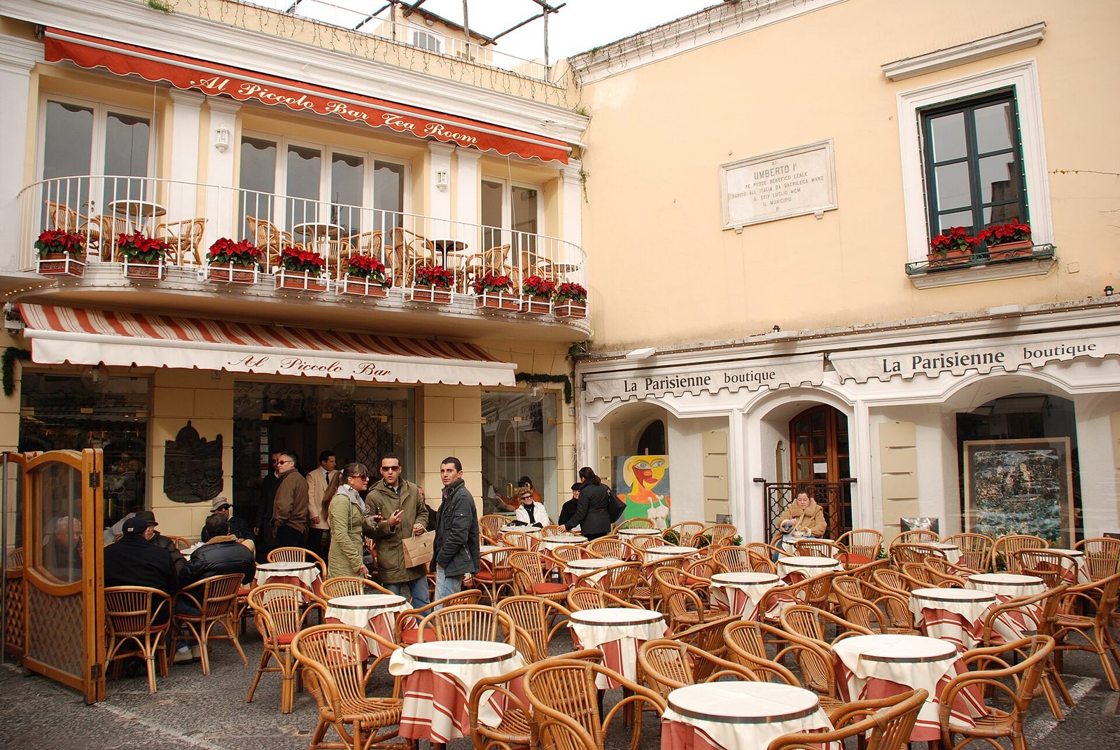 Café tables and people in coats outside a bar on the Piazzetta in Capri town