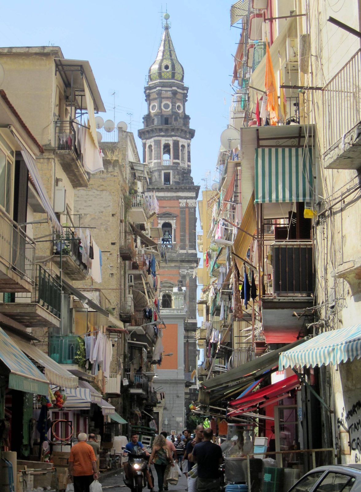 The bell tower of Santa Maria del Carmine rising over Via Lavinaio, centerpiece of one of the oldest Naples festivals