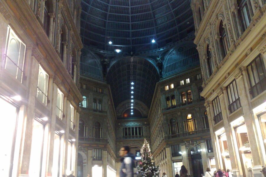 A Christmas tree under the glass dome of the Galleria Umberto I in Naples at night