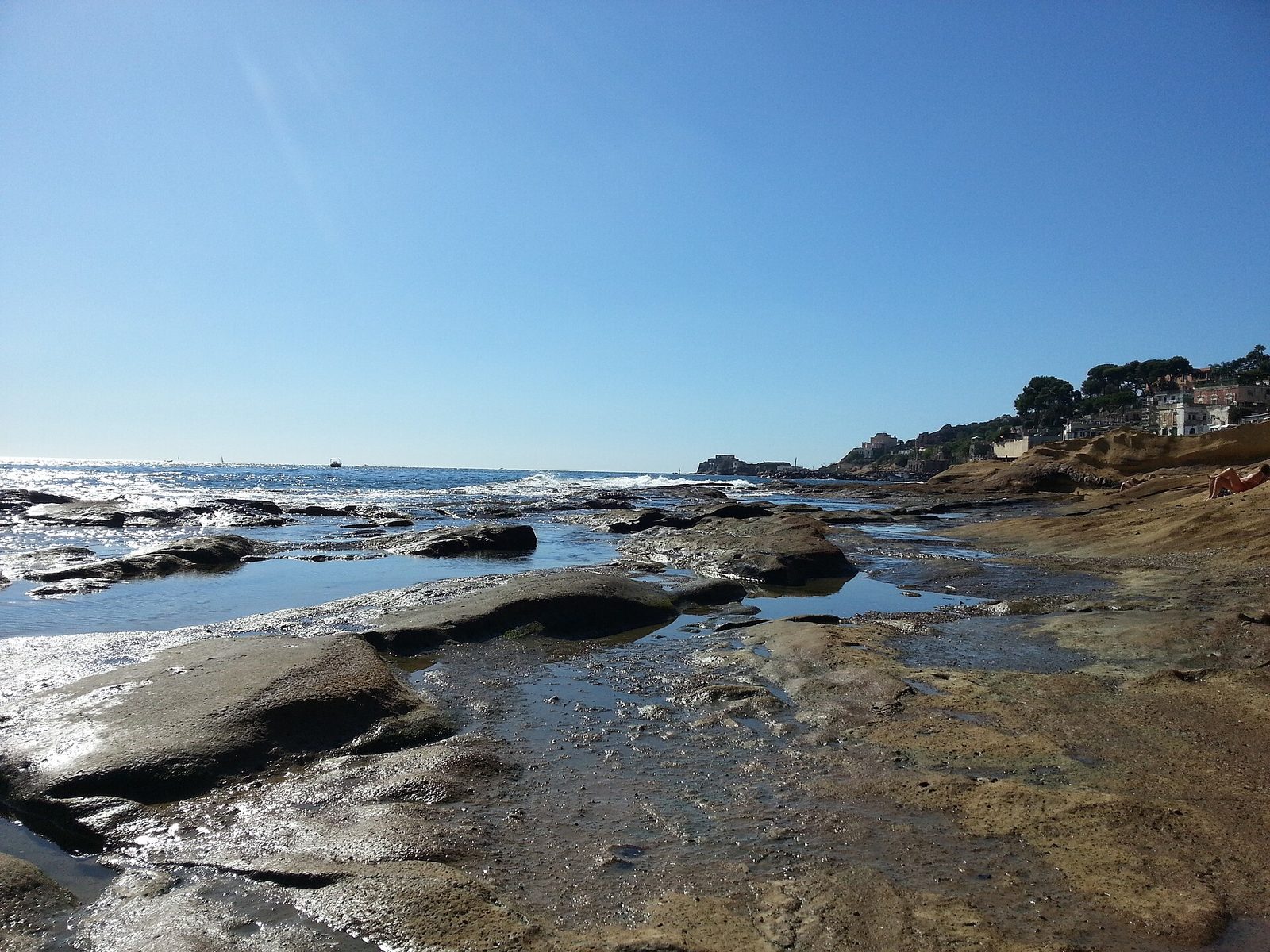 Flat volcanic rock platforms along the Marechiaro coast in Posillipo, looking toward Nisida