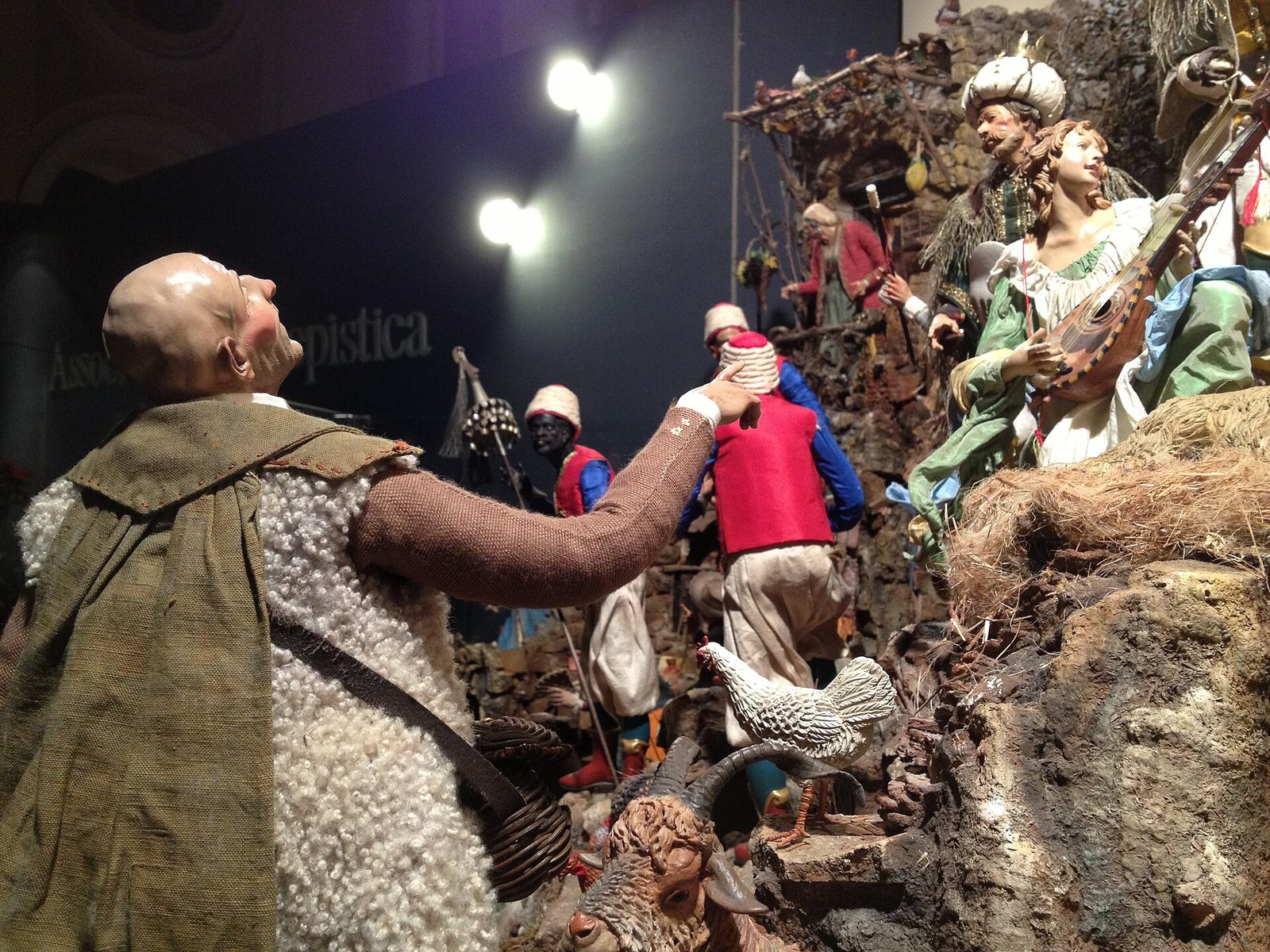 Hand-made Neapolitan presepe figures with painted faces and fabric clothes in a nativity scene