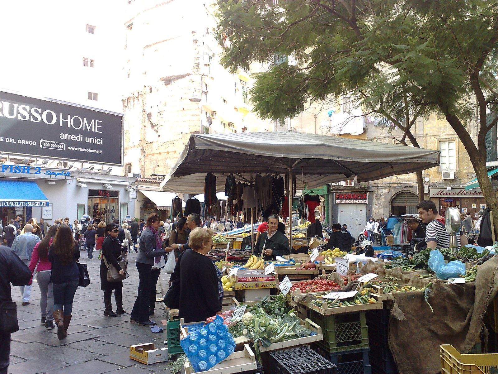 Vegetable and fruit stalls with shoppers at the Pignasecca street market in Naples