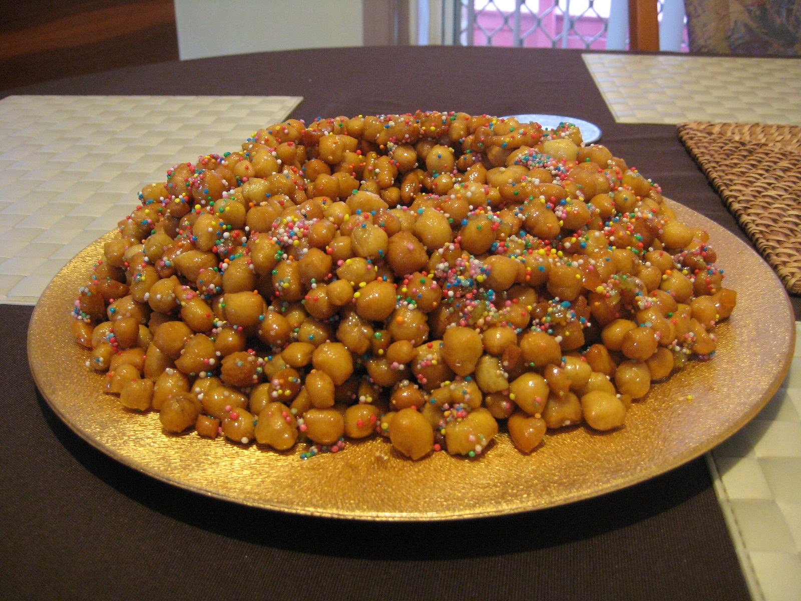 A ring of struffoli, Neapolitan Christmas honey balls decorated with colored sprinkles