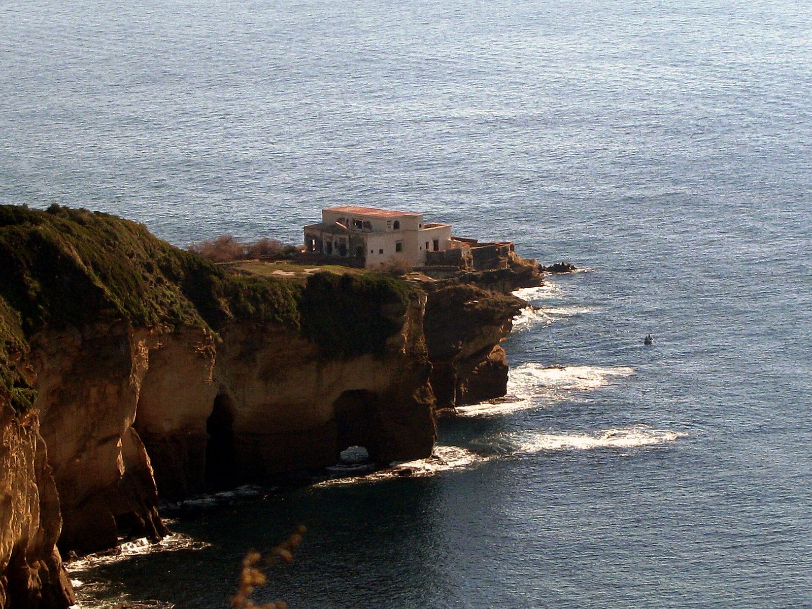 The yellow tuff cliffs of the Trentaremi bay on the Posillipo coast near the Gaiola