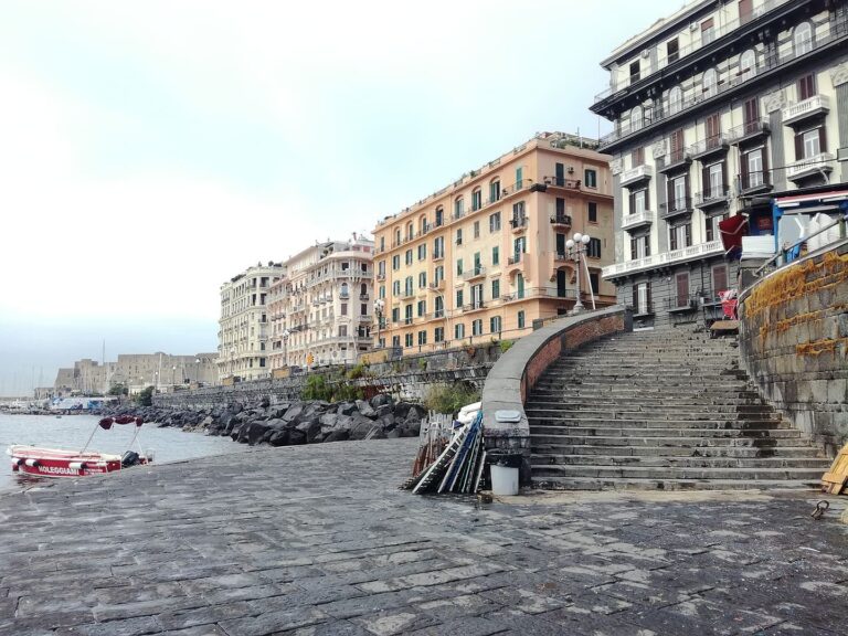 Steps leading down to the sea from the car-free Via Caracciolo promenade in Naples, Italy